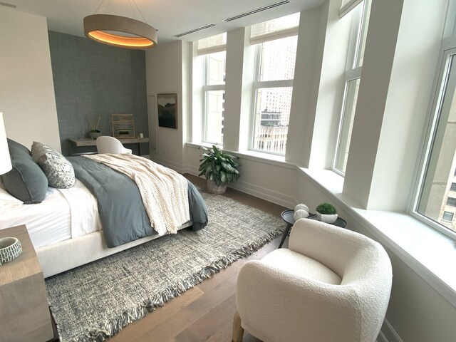 bedroom with dark hardwood / wood-style floors