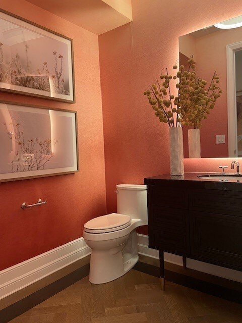 bathroom with decorative backsplash, vanity, tile walls, tiled shower, and toilet