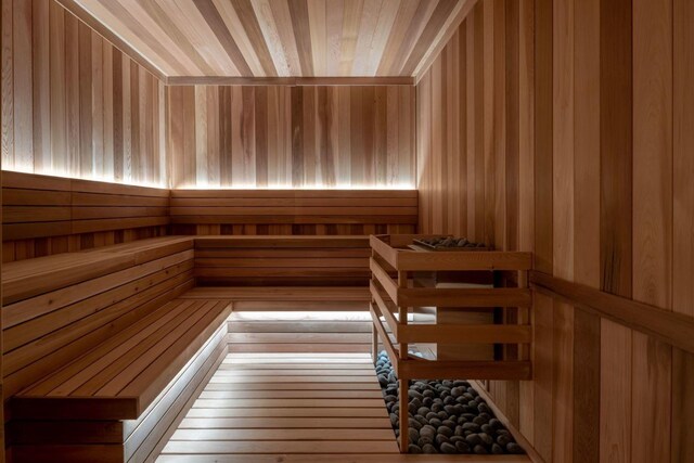 workout area featuring a tray ceiling, hardwood / wood-style flooring, and a healthy amount of sunlight