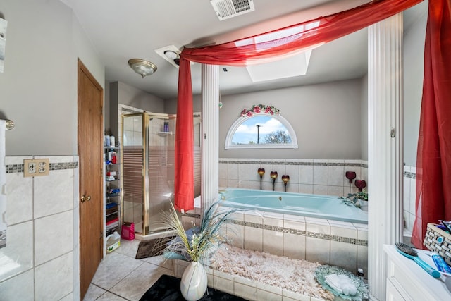 bathroom featuring shower with separate bathtub and tile flooring