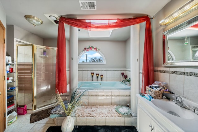 bathroom featuring tile walls, tile flooring, separate shower and tub, and oversized vanity