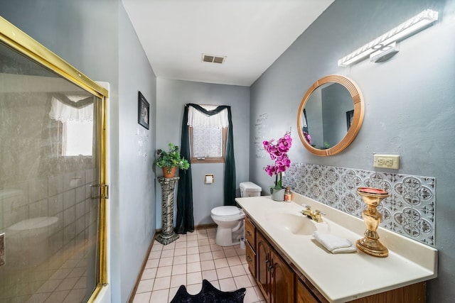 bathroom with a shower with shower door, tile flooring, toilet, and large vanity