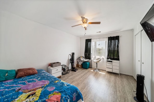 bedroom featuring a closet, ceiling fan, and light hardwood / wood-style flooring