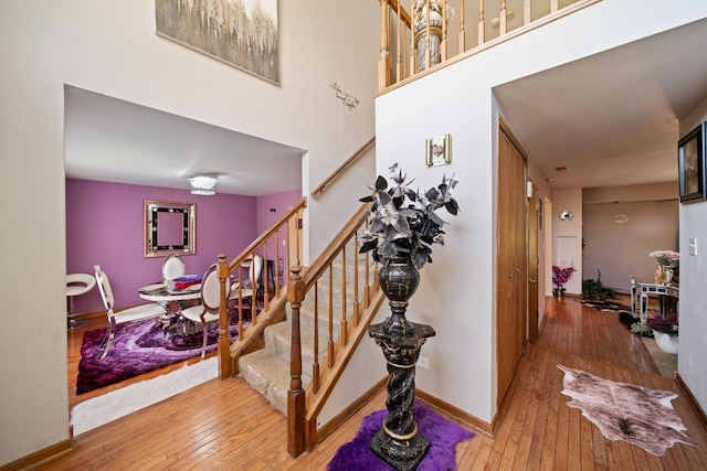 stairs with hardwood / wood-style floors