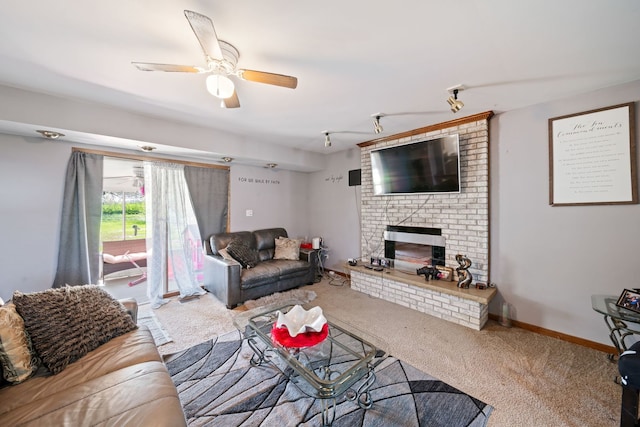 living room featuring brick wall, carpet, a brick fireplace, and ceiling fan