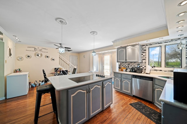 kitchen with plenty of natural light, ceiling fan, dishwasher, and wood-type flooring