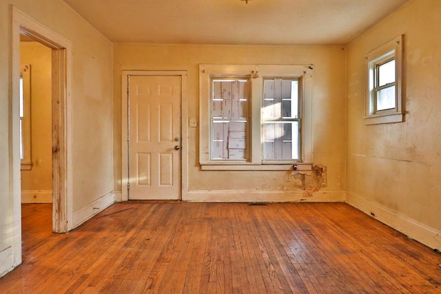 unfurnished room with wood-type flooring