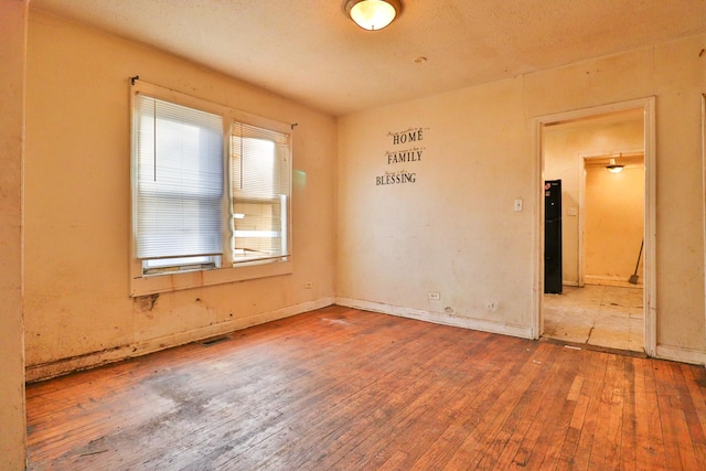 unfurnished room featuring wood-type flooring