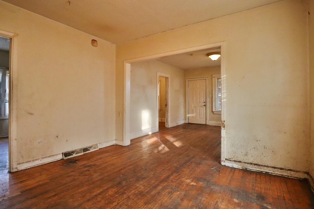 spare room with dark hardwood / wood-style floors