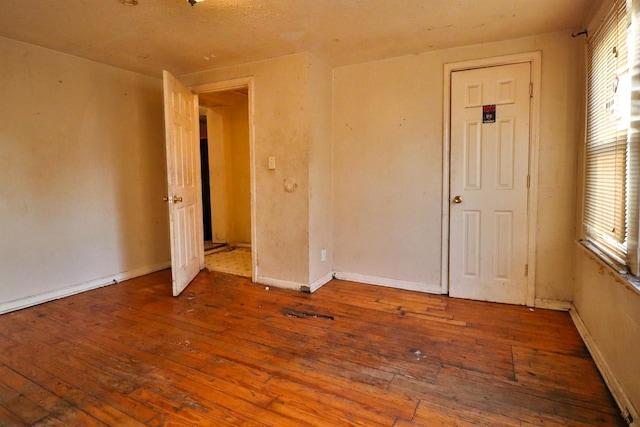 unfurnished room with plenty of natural light and wood-type flooring