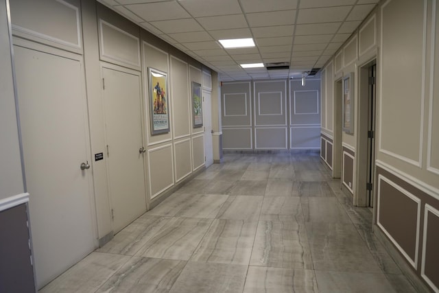 corridor featuring a paneled ceiling