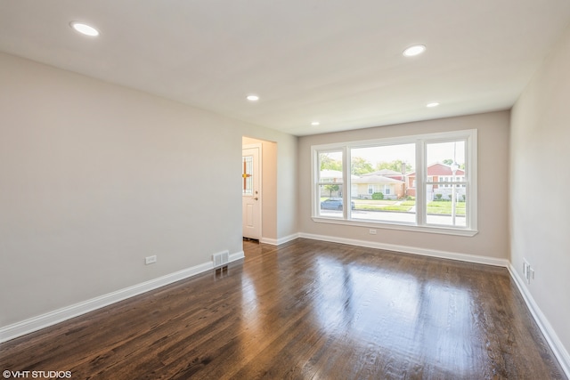 empty room featuring dark hardwood / wood-style flooring