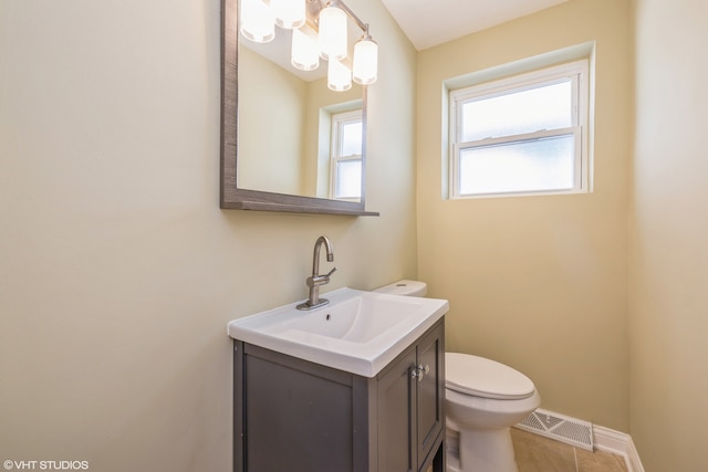 bathroom featuring toilet, tile floors, and vanity