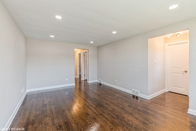 empty room with dark hardwood / wood-style flooring