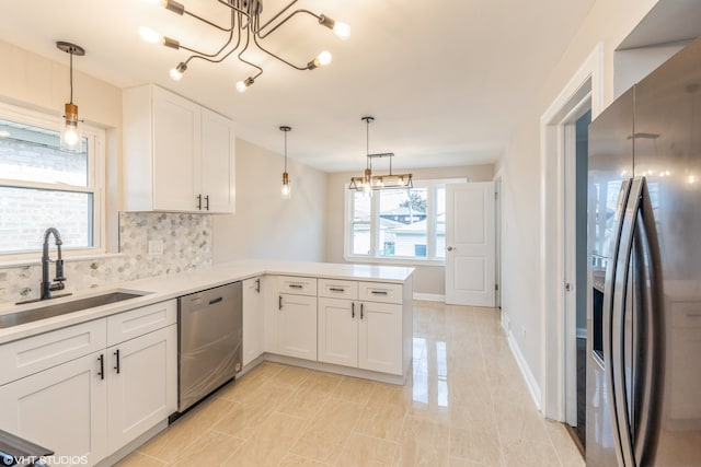 kitchen with kitchen peninsula, backsplash, stainless steel appliances, light tile flooring, and pendant lighting