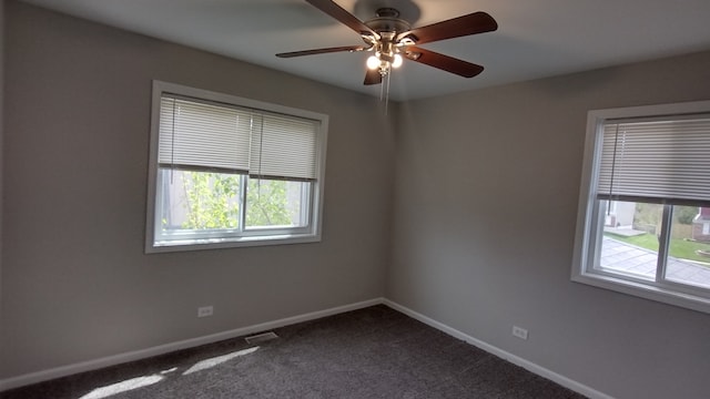 carpeted spare room with ceiling fan and a wealth of natural light