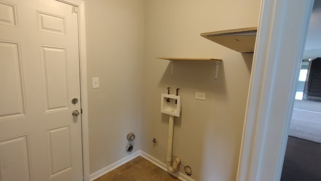 clothes washing area featuring dark tile flooring, hookup for a gas dryer, and washer hookup