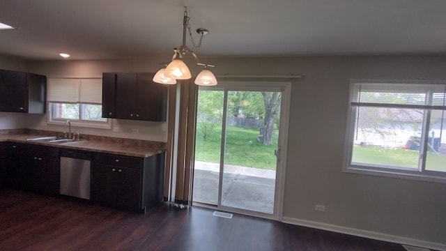 kitchen featuring decorative light fixtures, sink, dishwasher, and dark hardwood / wood-style floors