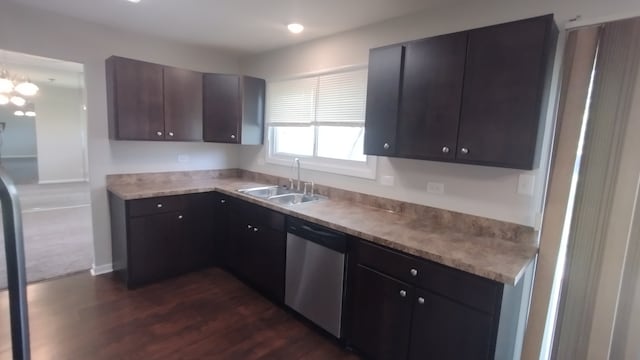 kitchen with stainless steel dishwasher, sink, dark hardwood / wood-style flooring, and dark brown cabinets