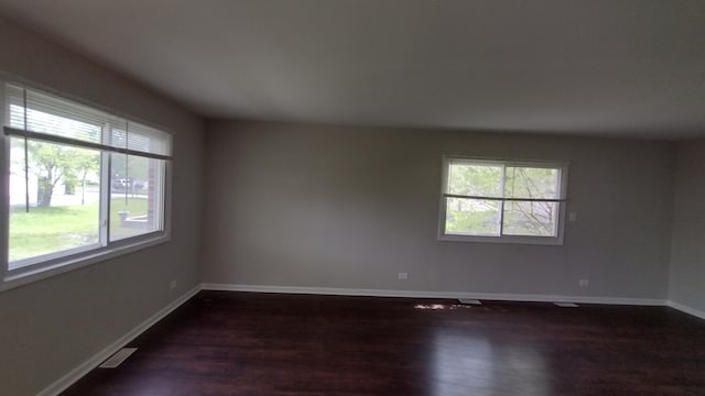 unfurnished room with dark hardwood / wood-style floors