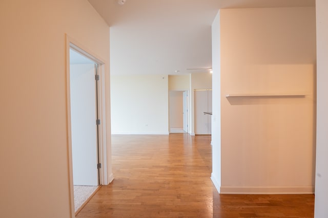 corridor with light hardwood / wood-style floors