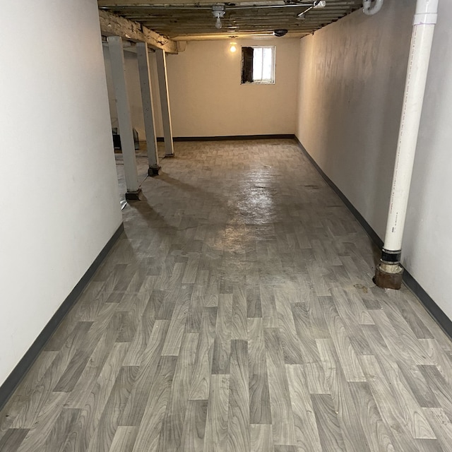 basement with hardwood / wood-style flooring