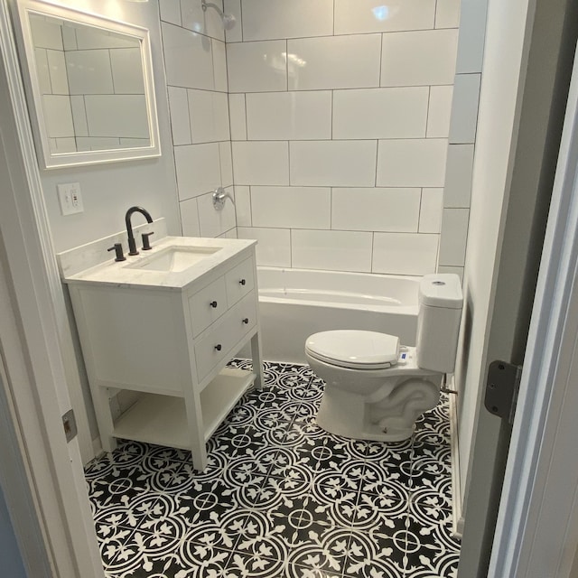 full bathroom featuring tile flooring, vanity, toilet, and tiled shower / bath combo