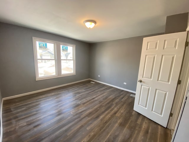 spare room with dark hardwood / wood-style floors