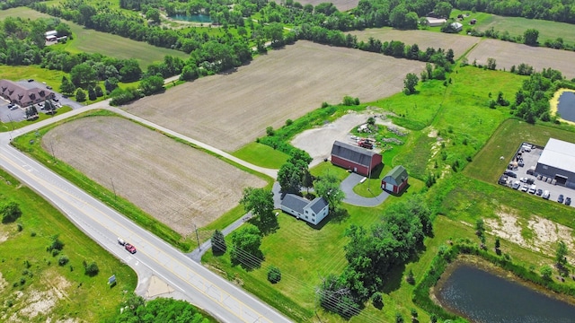 birds eye view of property featuring a rural view and a water view