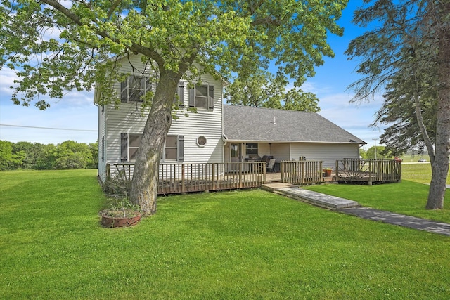 back of property with a lawn and a deck