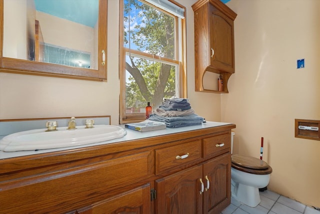 bathroom featuring tile patterned flooring, vanity, and toilet