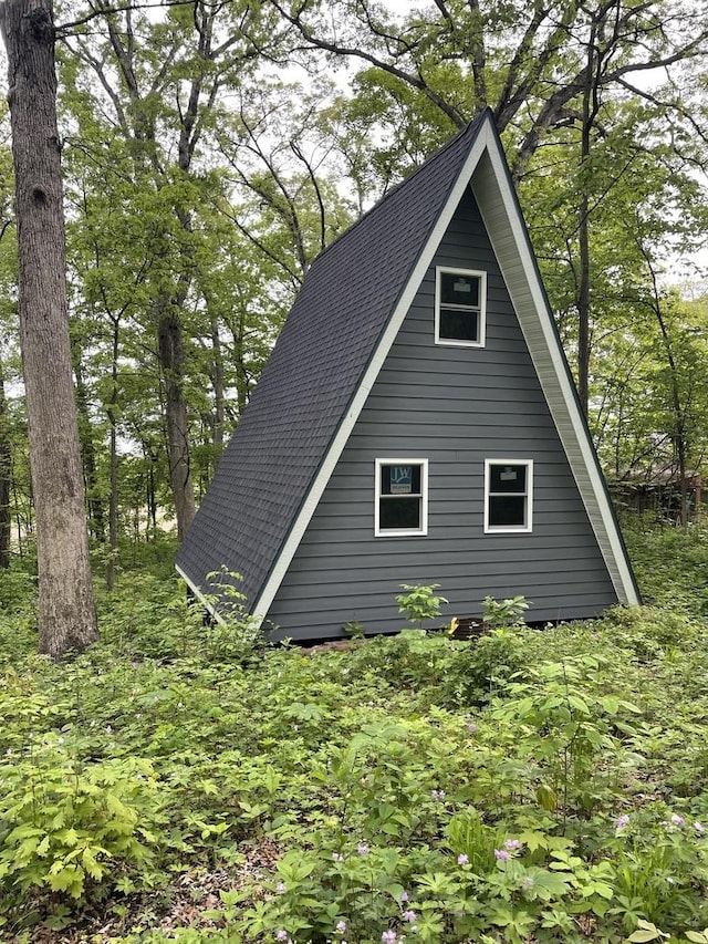 view of home's exterior featuring roof with shingles