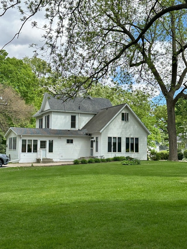 rear view of property with a yard