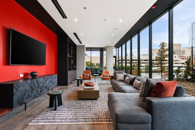 living room featuring hardwood / wood-style flooring and a wall of windows