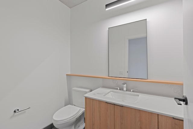 bathroom with toilet and large vanity