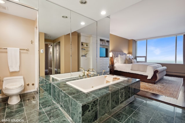 bathroom with tile flooring, baseboard heating, toilet, and a bathing tub