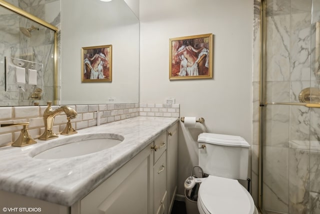 bathroom with an enclosed shower, backsplash, vanity, and toilet