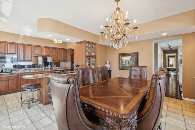 tiled dining space featuring an inviting chandelier