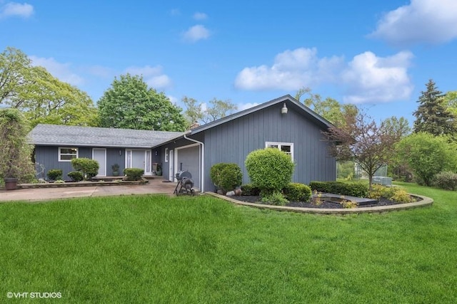 ranch-style home with a front lawn, driveway, and an attached garage