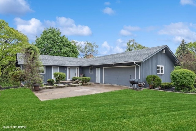 ranch-style house featuring an attached garage, driveway, roof with shingles, a chimney, and a front yard