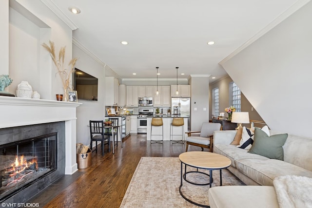 1646 W Augusta Blvd Unit 1, Chicago, IL 60622 - living room with dark wood-style flooring, a tiled fireplace, ornamental molding, and recessed lighting