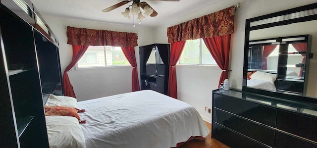 bedroom with ceiling fan and wood-type flooring