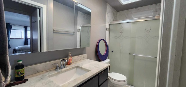 bathroom with an enclosed shower, vanity, and toilet