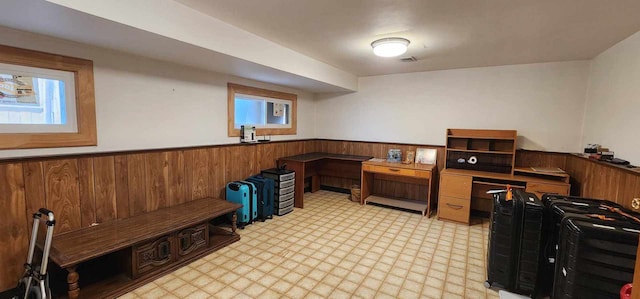 home office with built in desk and light tile floors