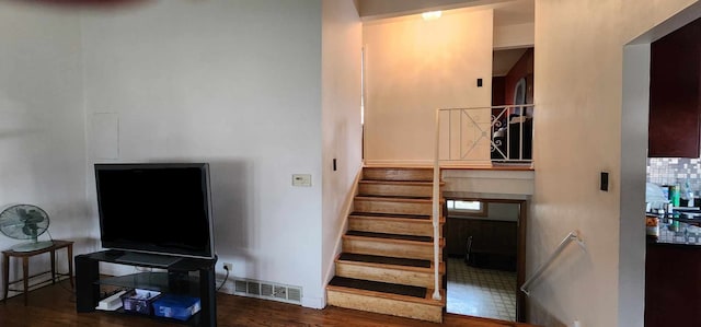 stairs featuring dark tile flooring