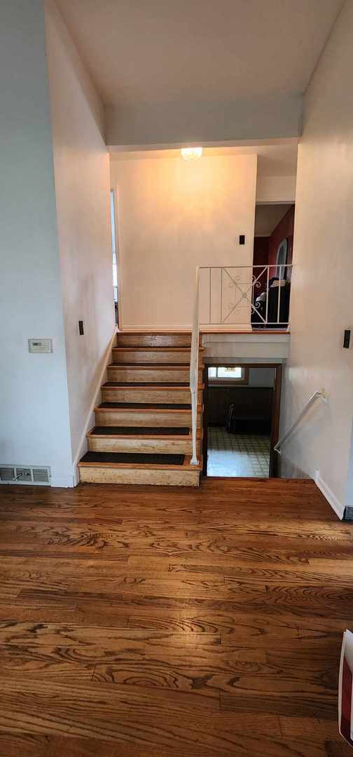 staircase featuring hardwood / wood-style floors