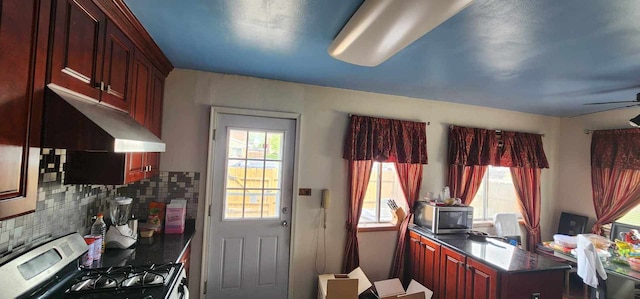 kitchen with backsplash, stove, and ceiling fan