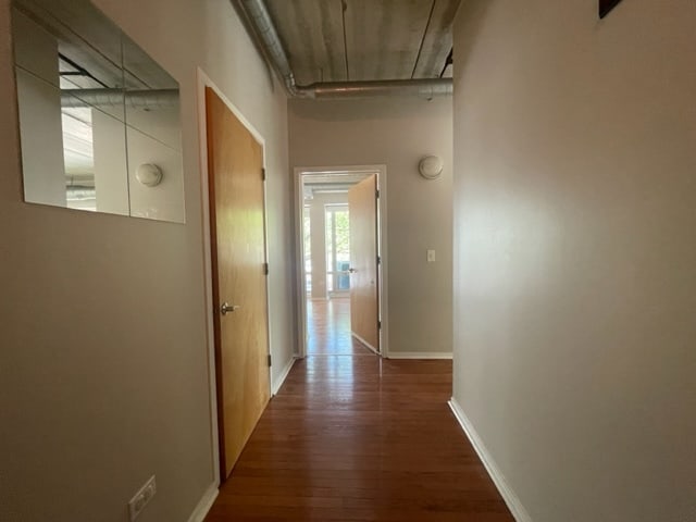 corridor featuring dark hardwood / wood-style flooring