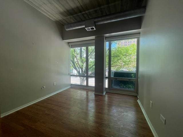 empty room featuring dark wood-type flooring