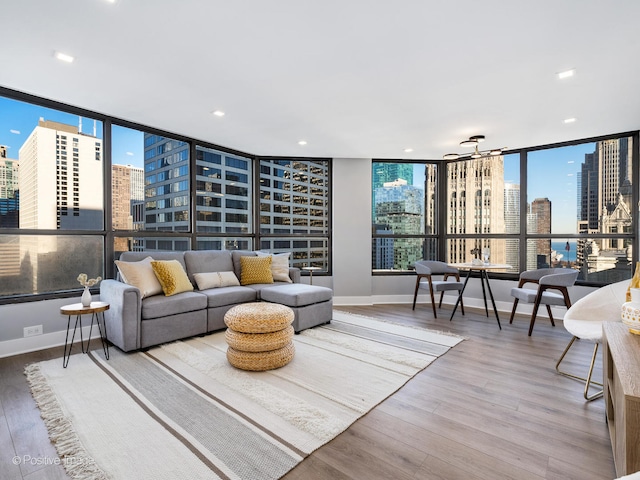 living room with light hardwood / wood-style floors and a wall of windows